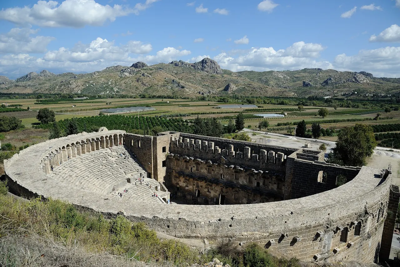 The semicircular stone seating and stage building of Aspendos theatre