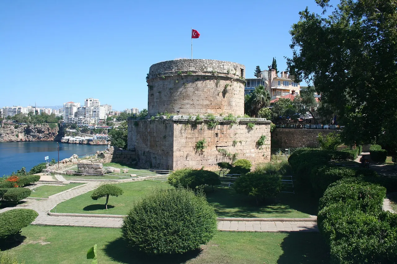 The rounded upper stonework and square base of Hidirlik Tower