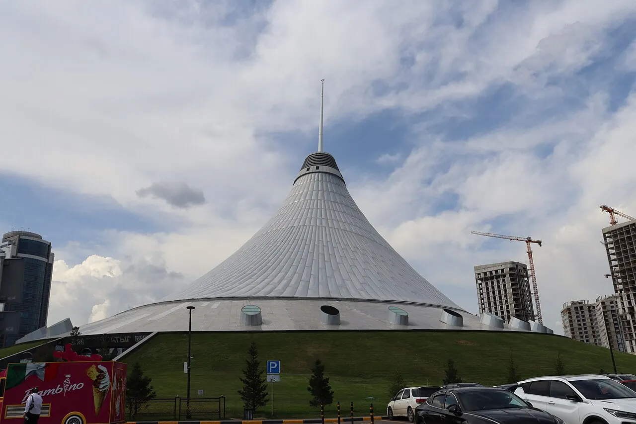 The large sloping tent roof of Khan Shatyr above its entrance grounds