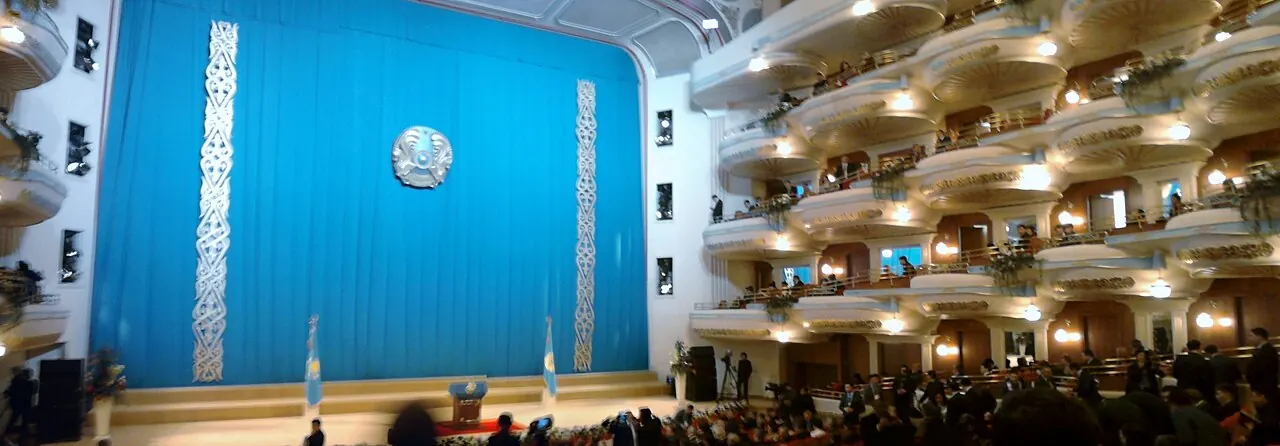 Seating balconies and the stage curtain inside the Astana Opera auditorium