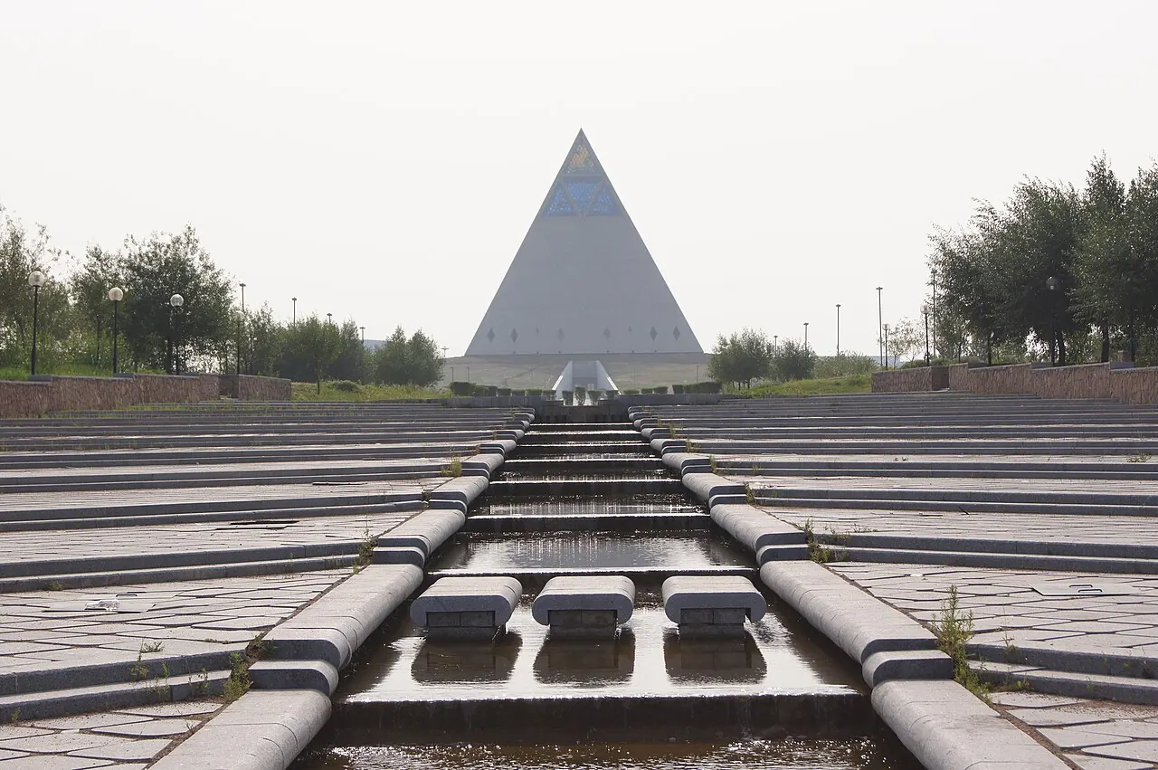 The glass-topped pyramid of the Palace of Peace and Reconciliation beyond landscaped terraces