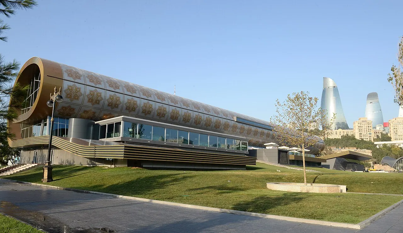 The rolled-carpet-shaped Azerbaijan National Carpet Museum beside its waterfront gardens