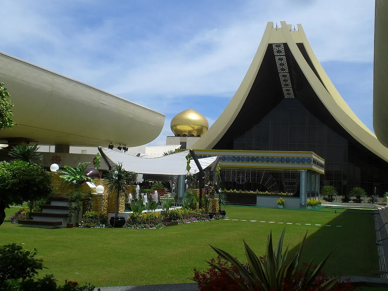 Istana Nurul Iman's covered entrance, steep roof and distant golden dome