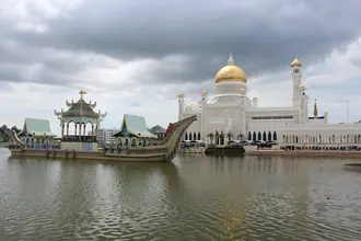 Omar Ali Saifuddien Mosque's golden dome and ceremonial barge beside the lagoon