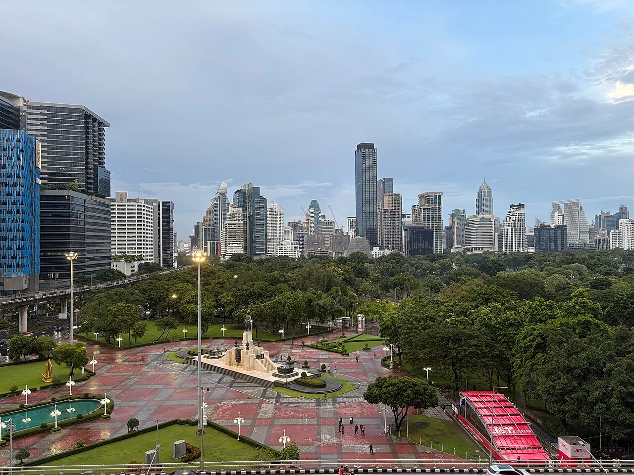 Lumphini Park's lake and tree canopy surrounded by central Bangkok buildings