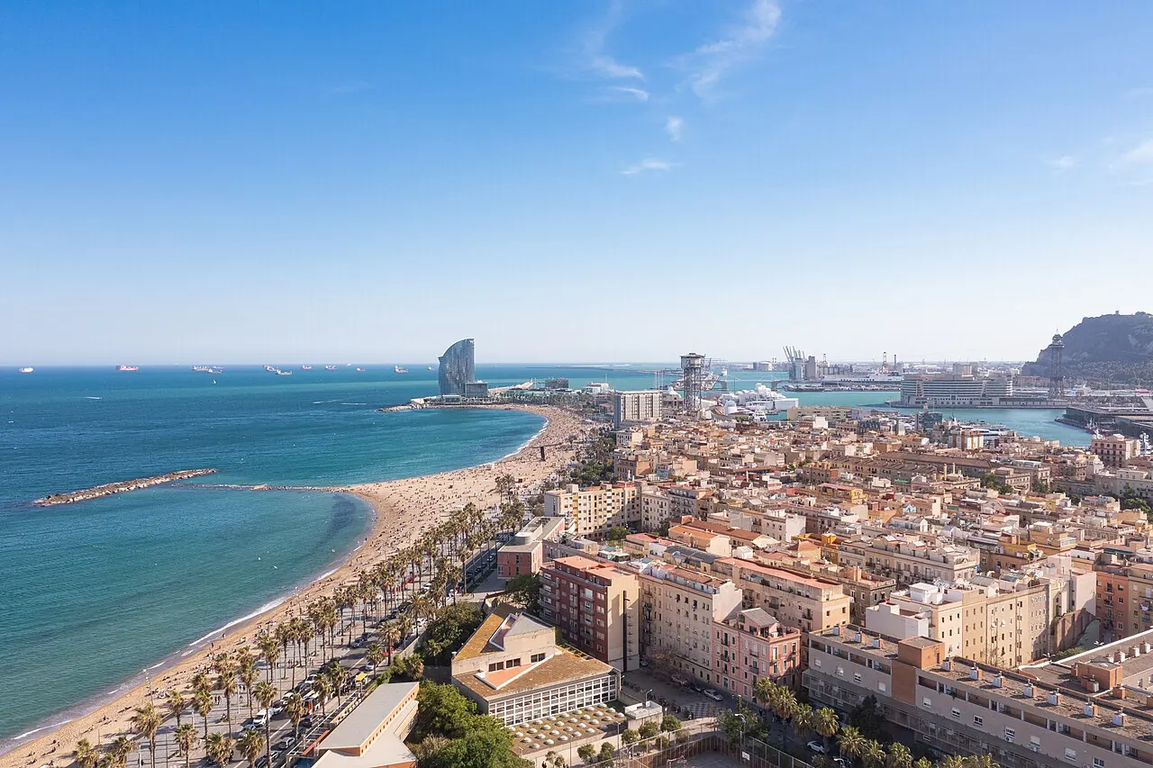 Aerial view of Barceloneta's beach, neighbourhood blocks and Port Vell