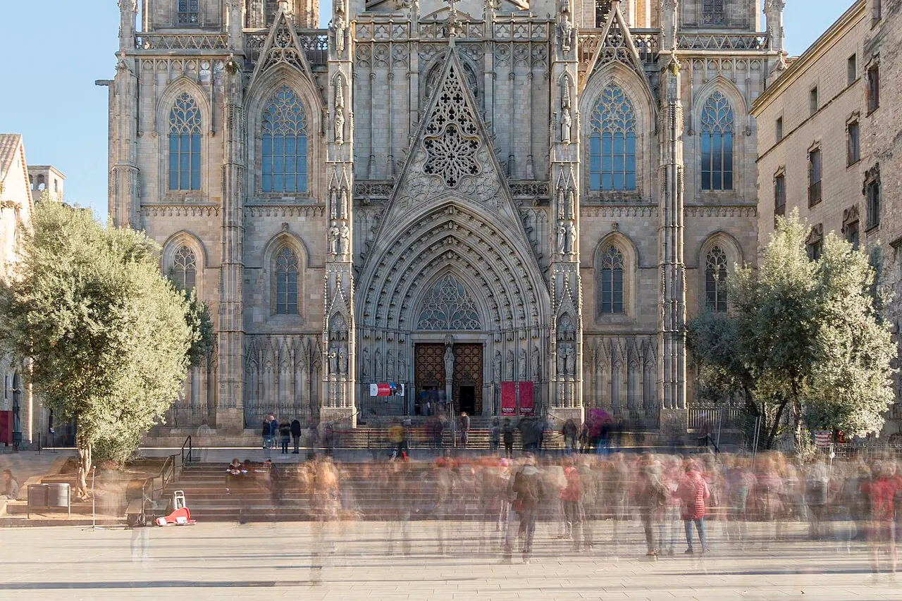 The Gothic facade and spires of Barcelona Cathedral above its square