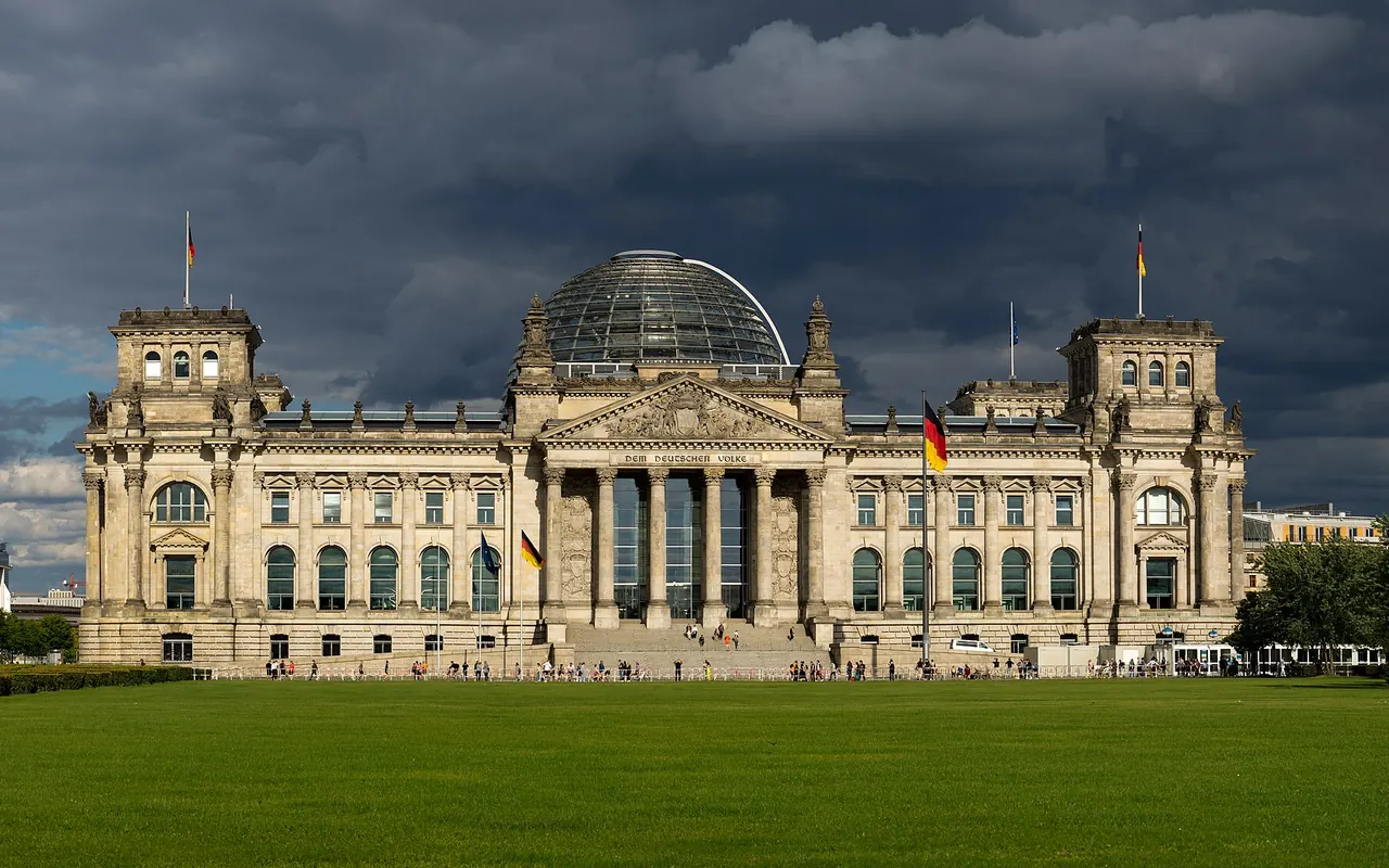 The Reichstag's west facade and glass dome behind its front lawn