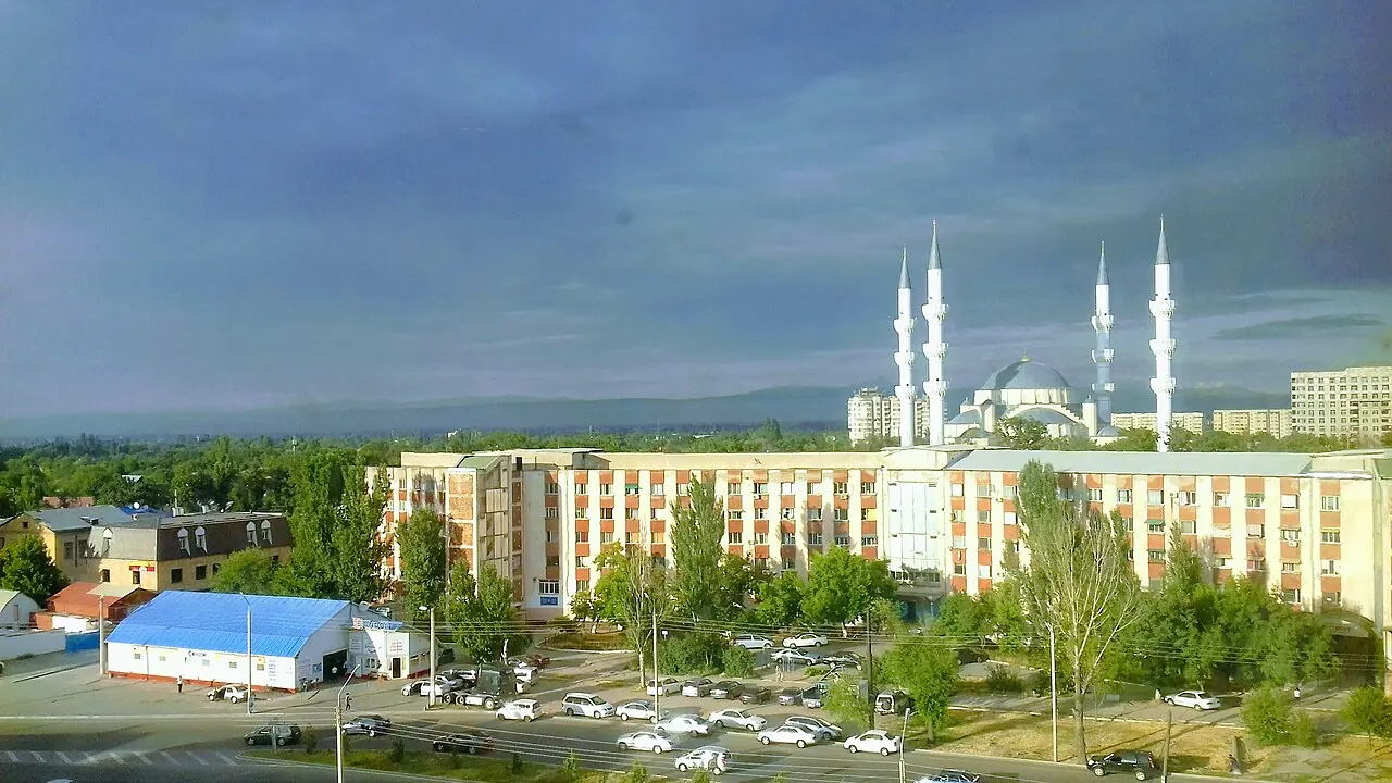 The domes and minarets of Bishkek Central Mosque beyond surrounding streets