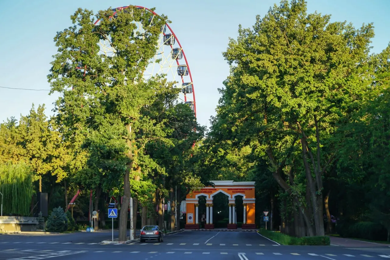 Tree-lined paths and amusement structures in Panfilov Park, Bishkek