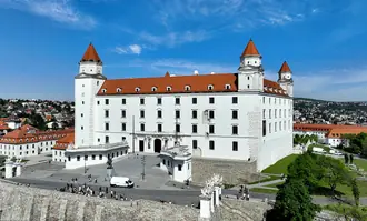 The white four-towered Bratislava Castle above the Danube-facing hillside