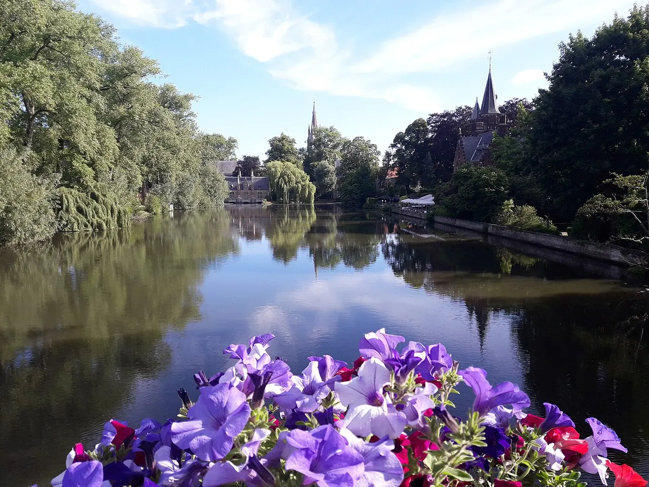 Waterside buildings and reflections beside Minnewater in Bruges