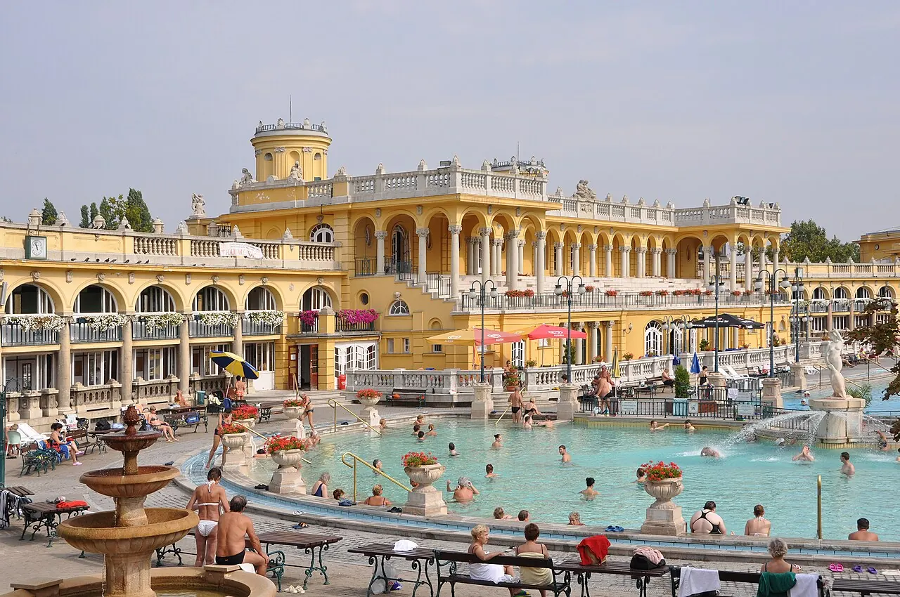 Outdoor pools and yellow colonnades at Szechenyi Thermal Bath