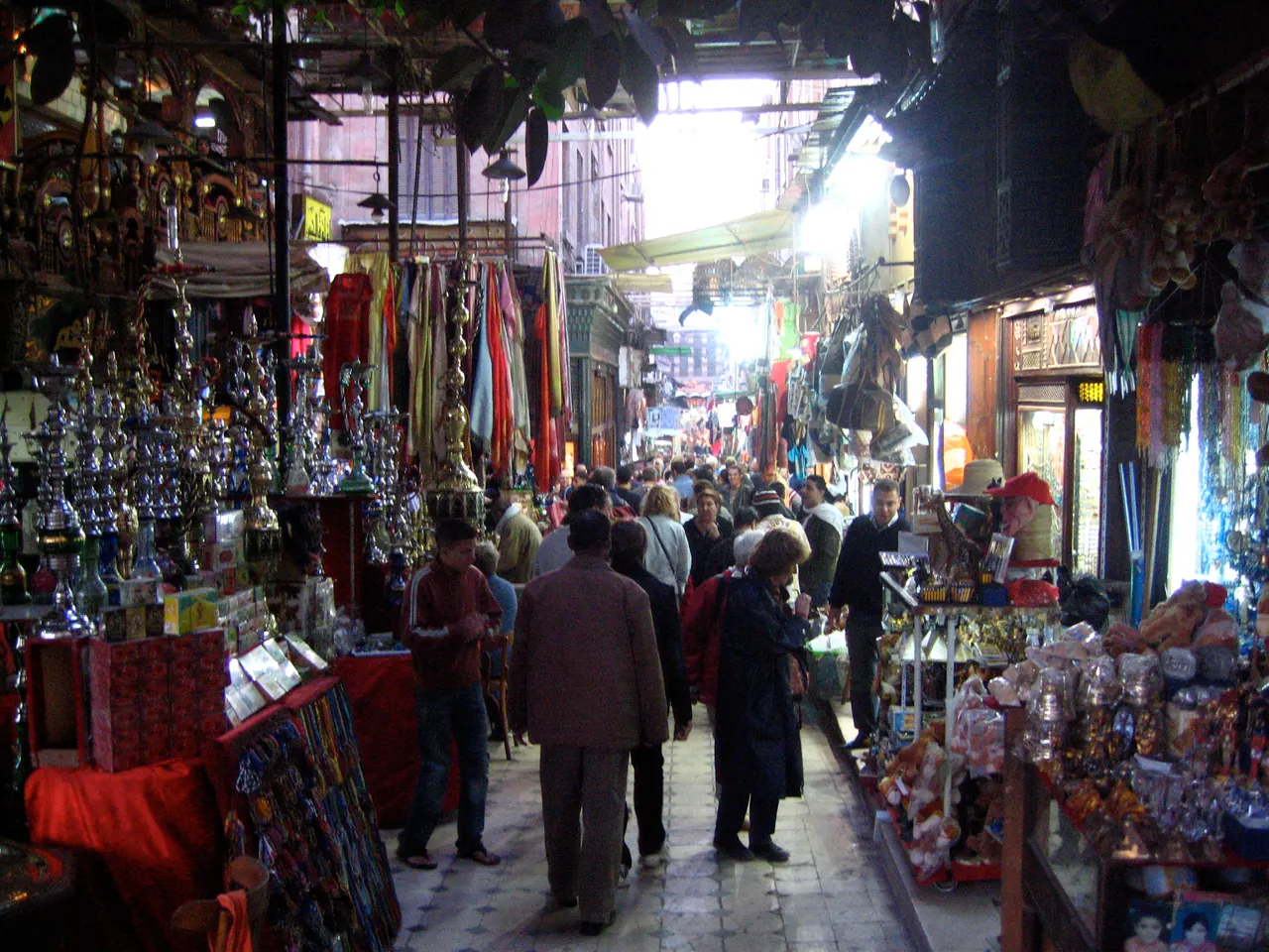 Market stalls and shoppers along a lane in Khan al-Khalili