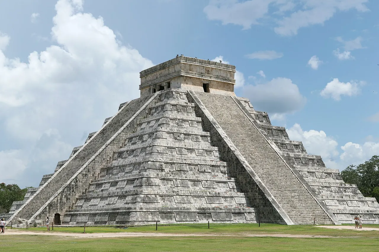 El Castillo pyramid at Chichen Itza beneath a cloudy sky
