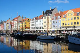 Colourful canal houses and moored boats along Nyhavn in Copenhagen