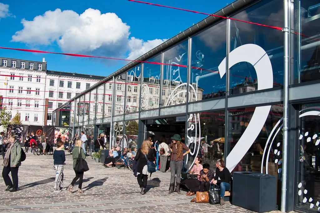 Visitors outside the glass market halls at Torvehallerne
