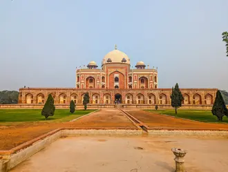 Humayun's Tomb, its white dome and red-sandstone facade beyond a formal garden path