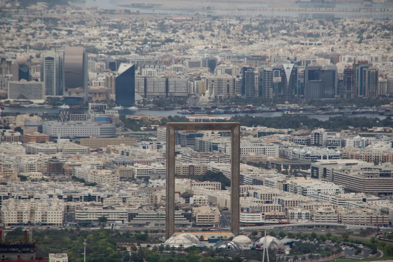 Dubai Frame's rectangular gold structure rising above Zabeel Park