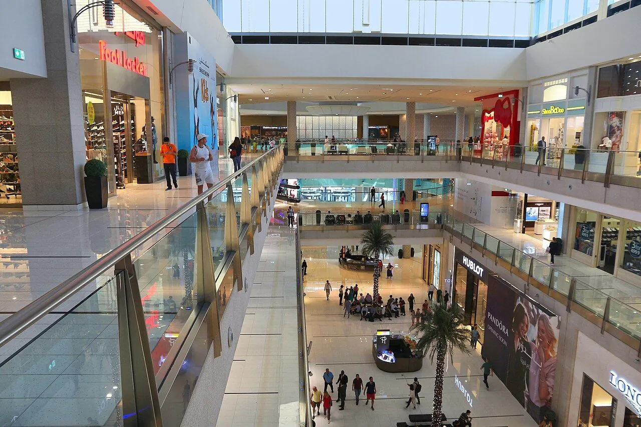 Palm trees, balconies and broad indoor walkways in Dubai Mall