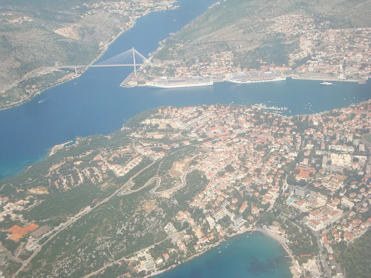 The Lapad peninsula in the foreground of an aerial view, with Gruz harbour and the bridge beyond