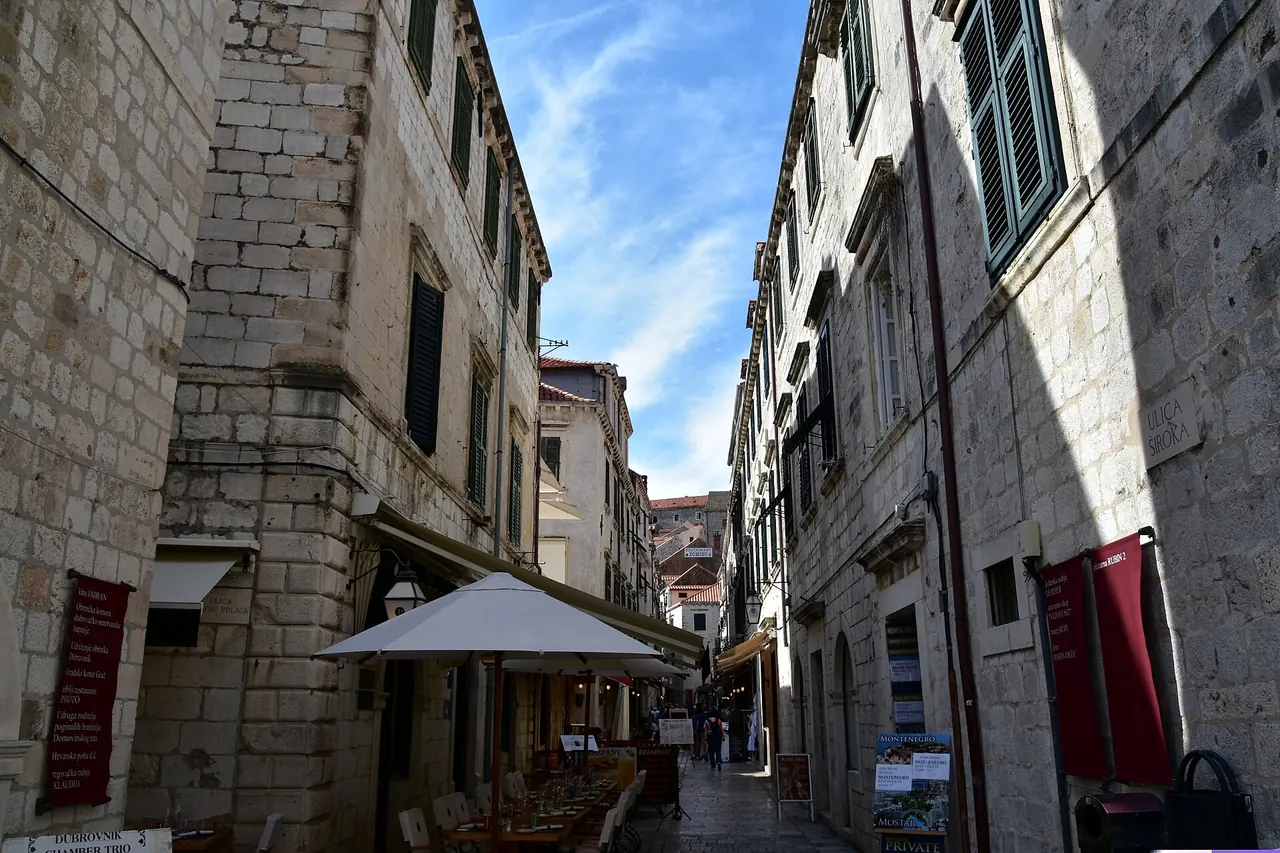 Stone buildings and cafe awnings along Stradun in Dubrovnik