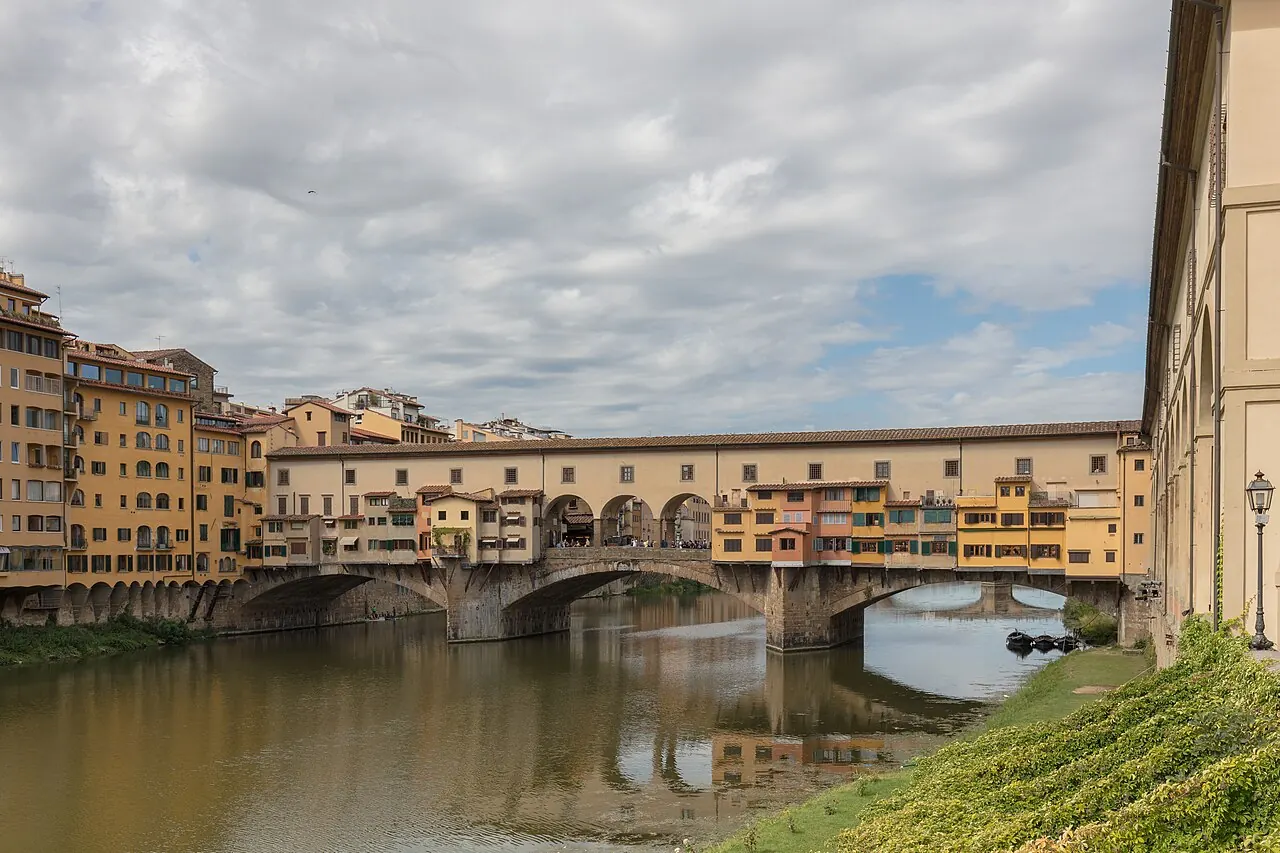 Ponte Vecchio and its shop-lined structure reflected in the Arno