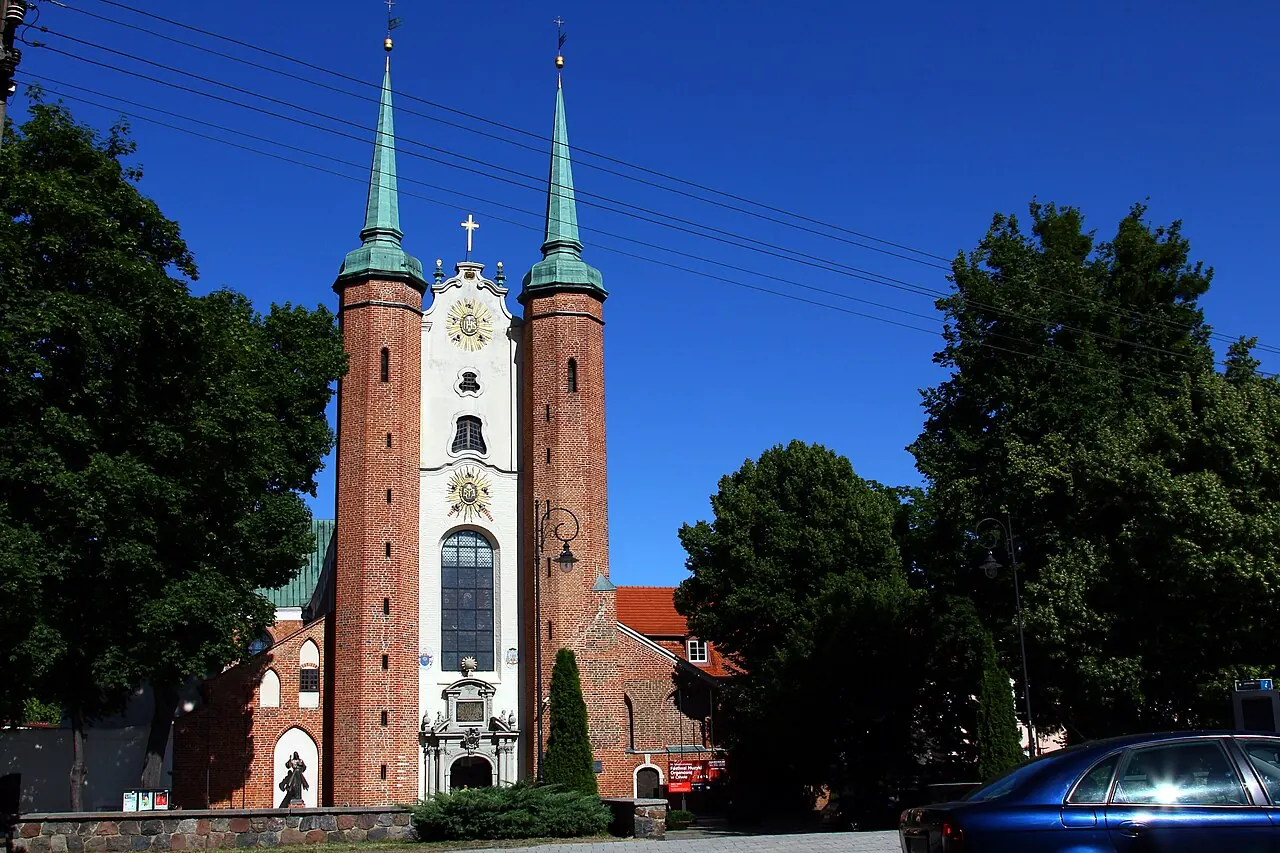 The twin red-brick towers and entrance facade of Oliwa Cathedral in Gdansk
