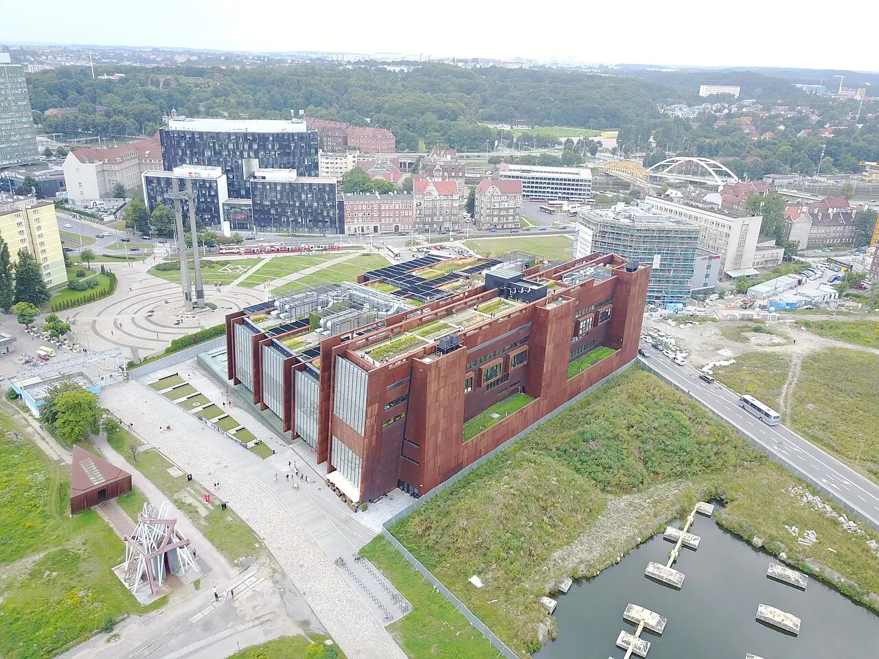 The rust-coloured European Solidarity Centre building within the Gdansk shipyard area