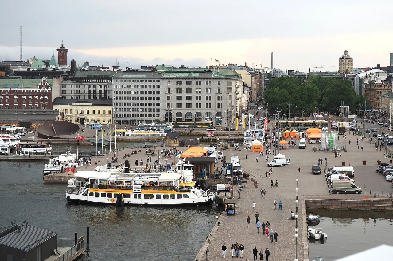 Market stalls and orange canopies beside Helsinki's South Harbour