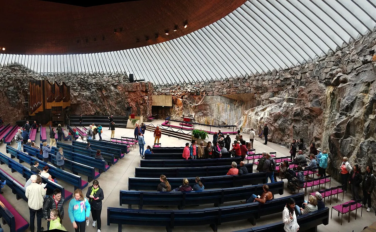 Temppeliaukio Church's exposed rock walls beneath the circular copper ceiling