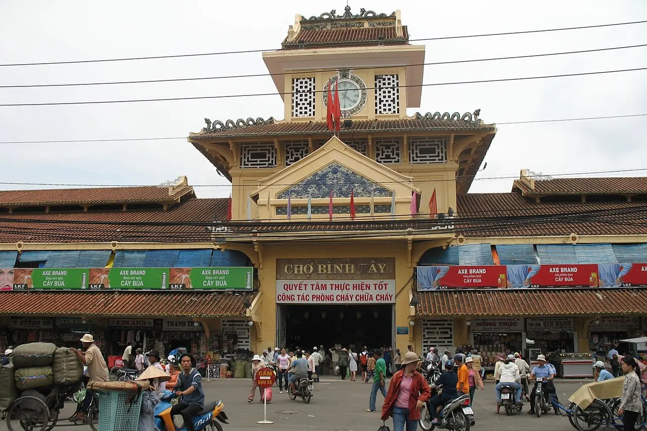 Binh Tay Market's roofline and busy main entrance in Cholon