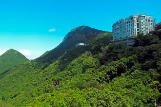 Wooded slopes and buildings of Victoria Peak above Victoria Gap in Hong Kong