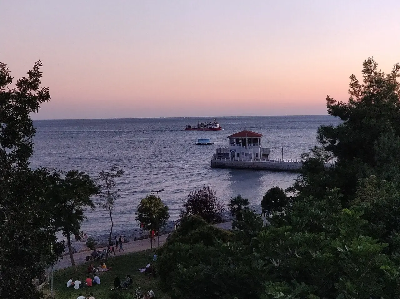 Moda pier and the waterfront promenade seen from the park at dusk