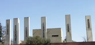 Concrete pillars and flags in the outdoor precinct of the Apartheid Museum in Johannesburg