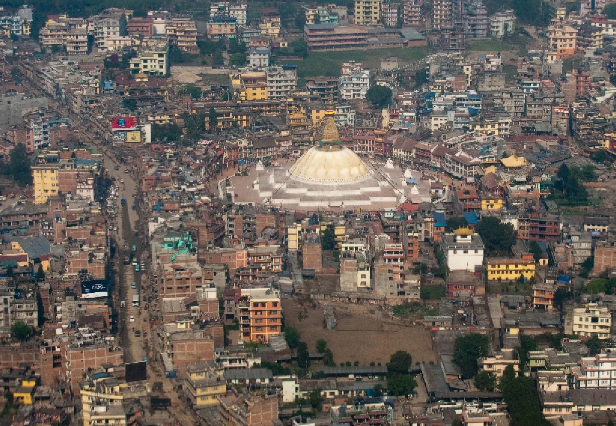 Boudhanath stupa and its circular plaza surrounded by Kathmandu's buildings