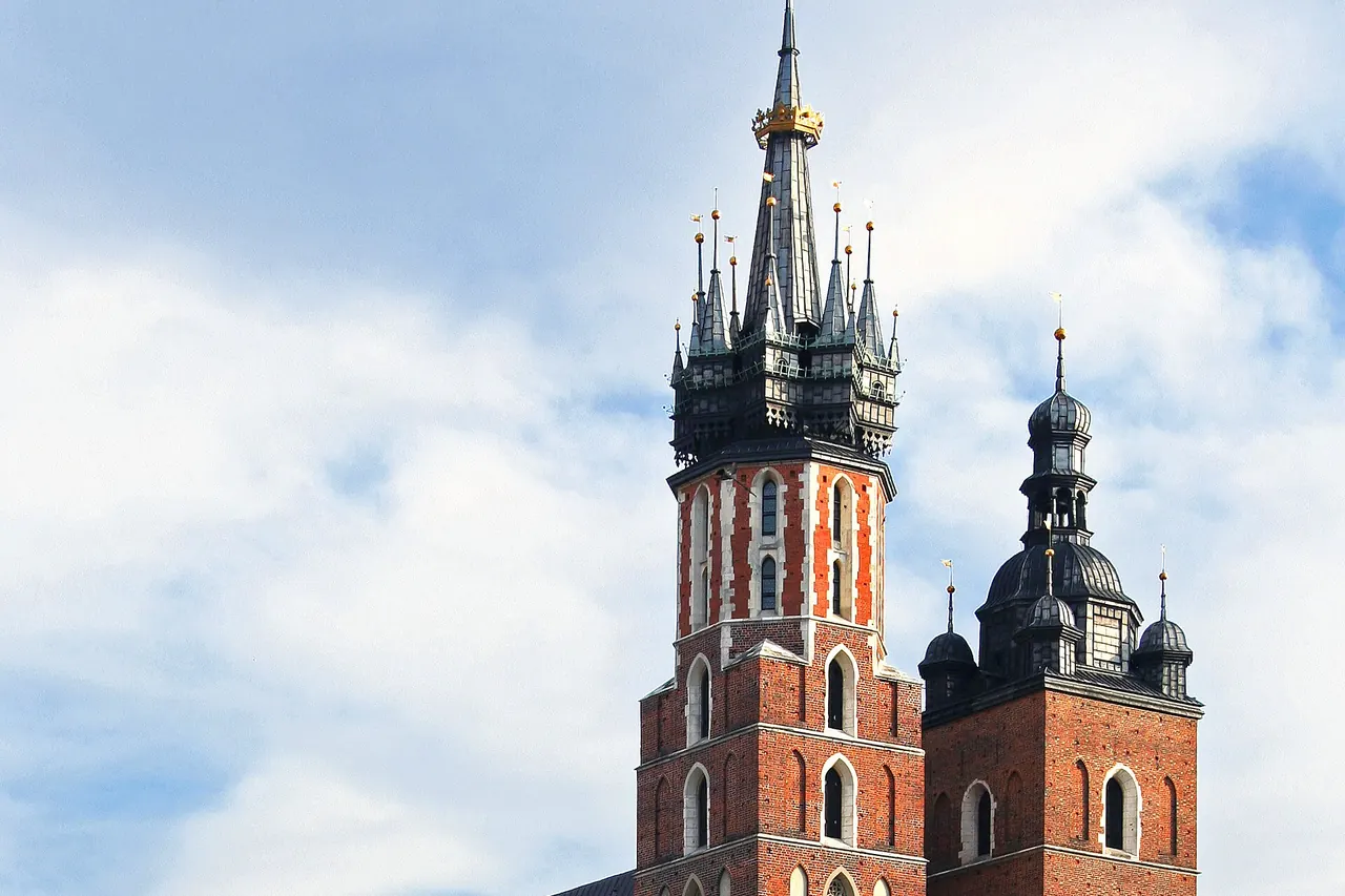 St Mary's Basilica's brick facade and unequal towers above Krakow's square