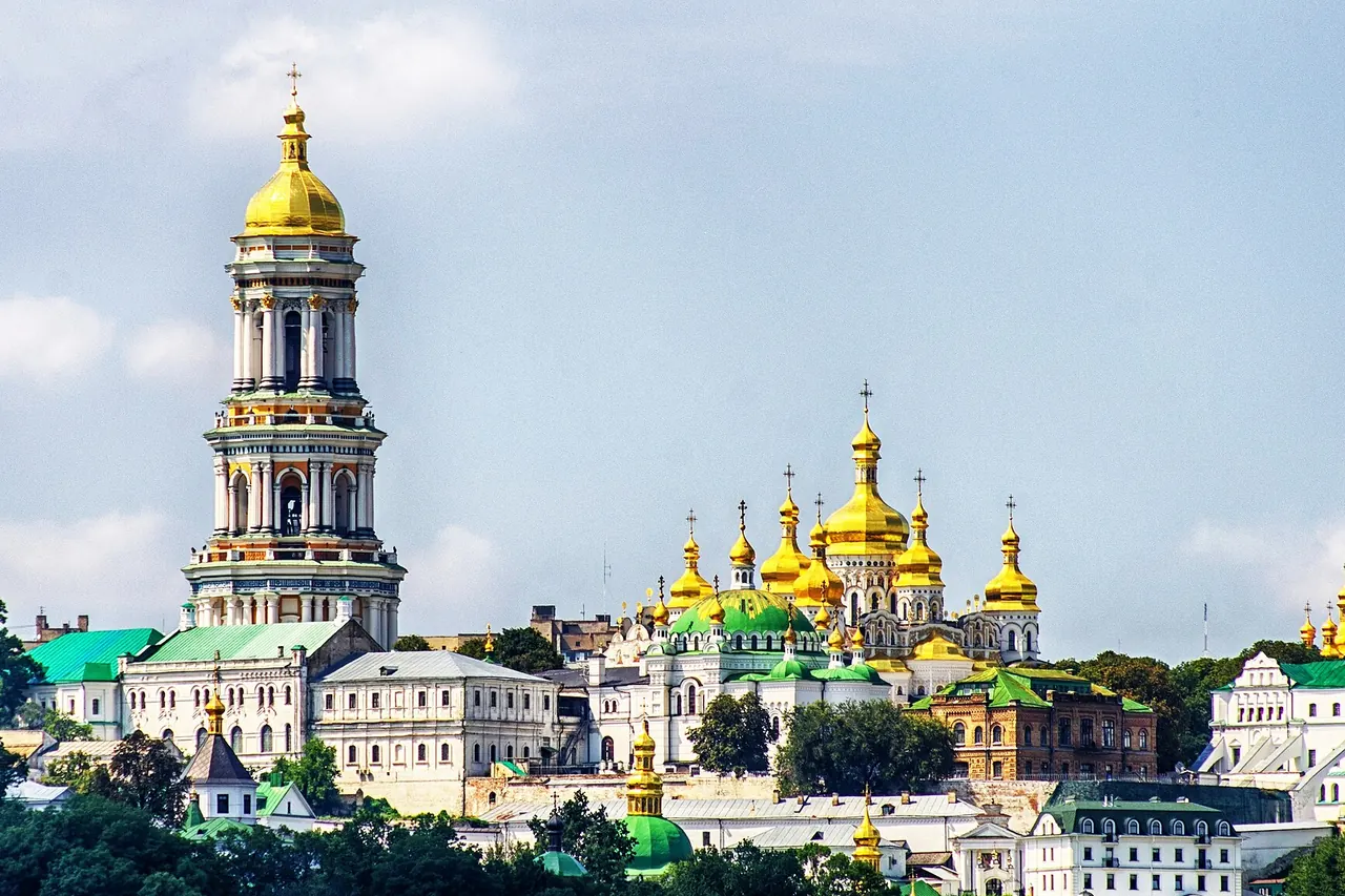 The towers and gilded domes of Kyiv Pechersk Lavra above the Dnipro's wooded slopes