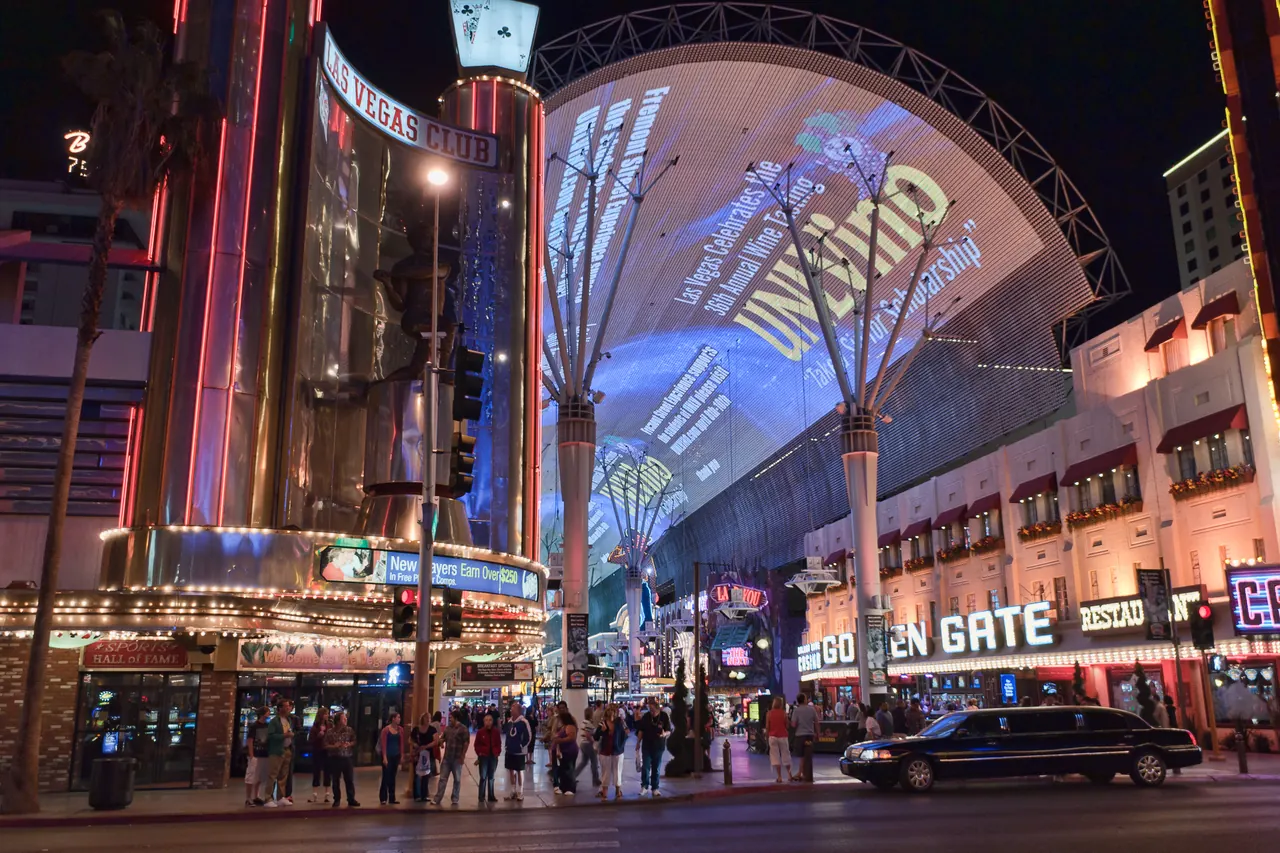 Casino signs and the illuminated canopy along Fremont Street Experience