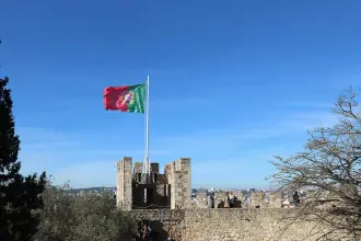 Stone ramparts and a Portuguese flag at Lisbon's Sao Jorge Castle