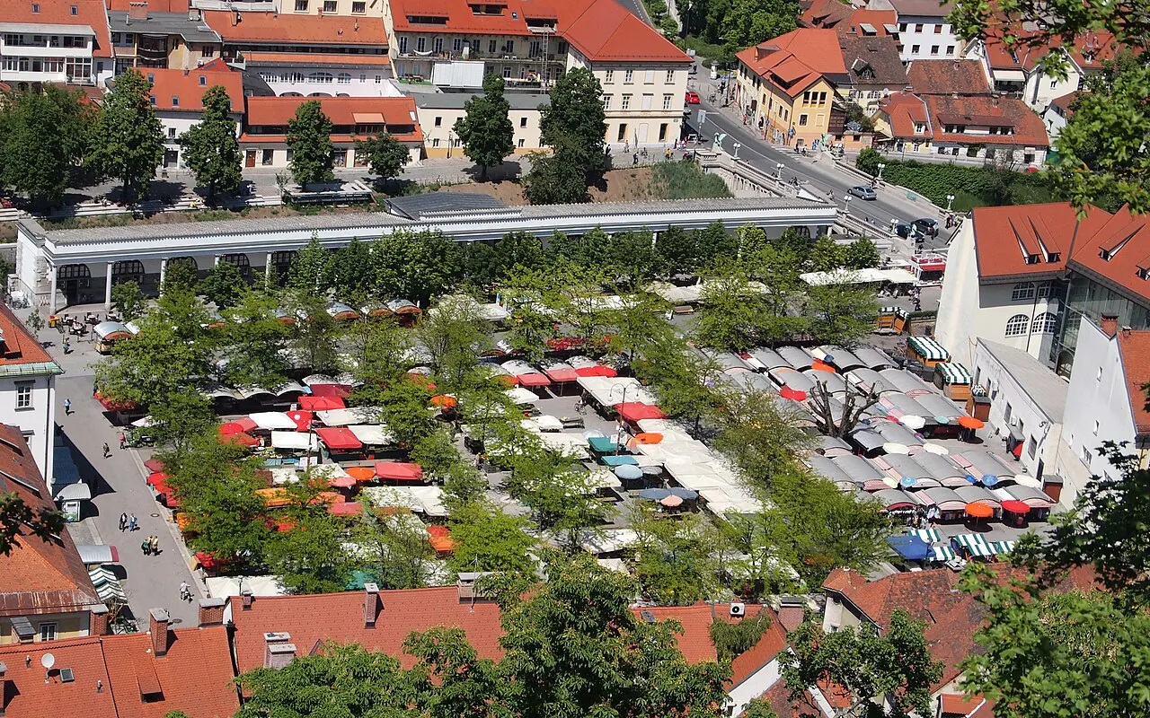 Open-air stalls and covered riverside buildings at Ljubljana Central Market