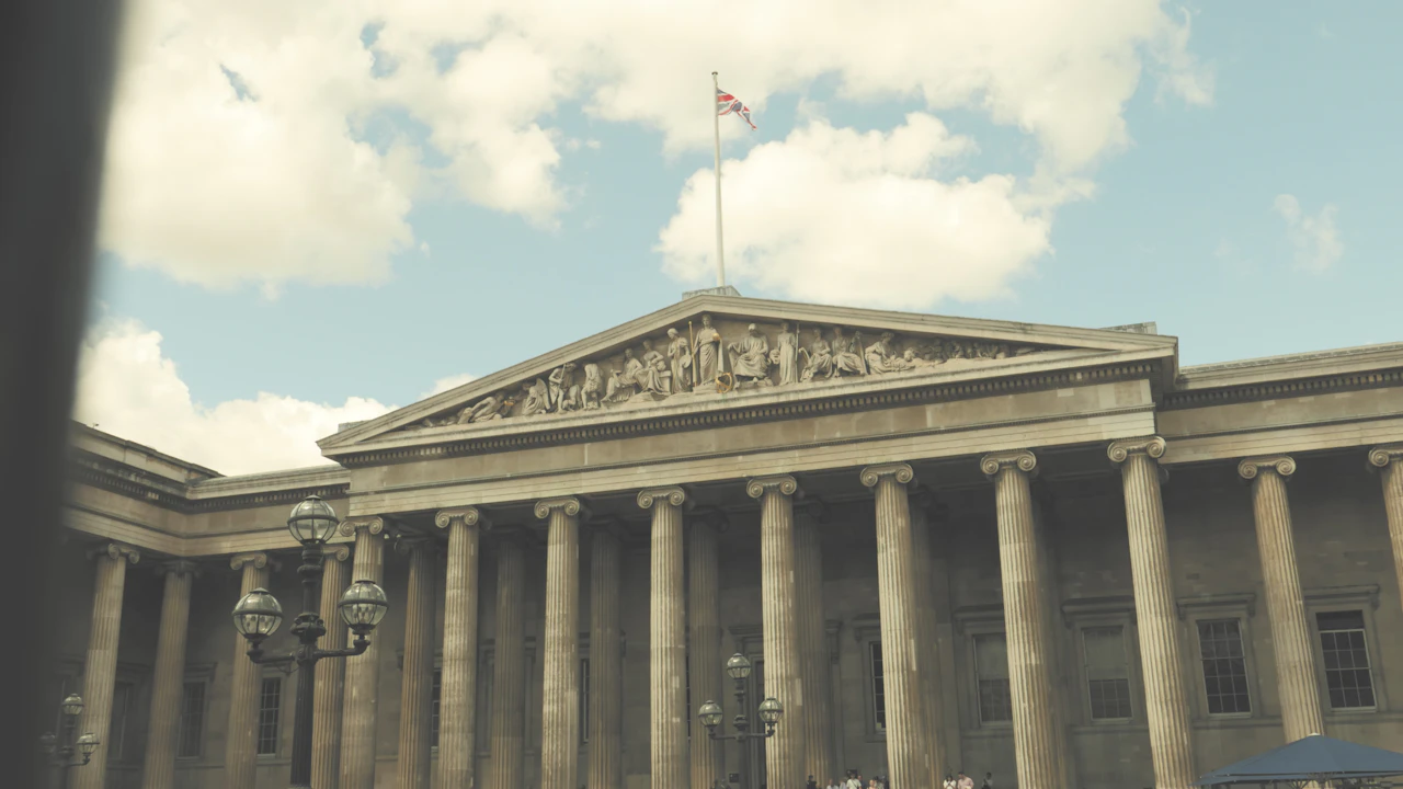 The British Museum entrance with Ionic columns, sculpted pediment and Union flag