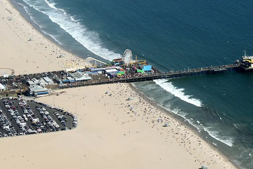 Santa Monica Pier extending into the Pacific with its amusement rides