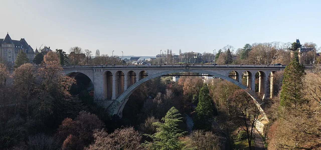 Stone arches of Adolphe Bridge spanning Luxembourg City’s wooded Petrusse valley