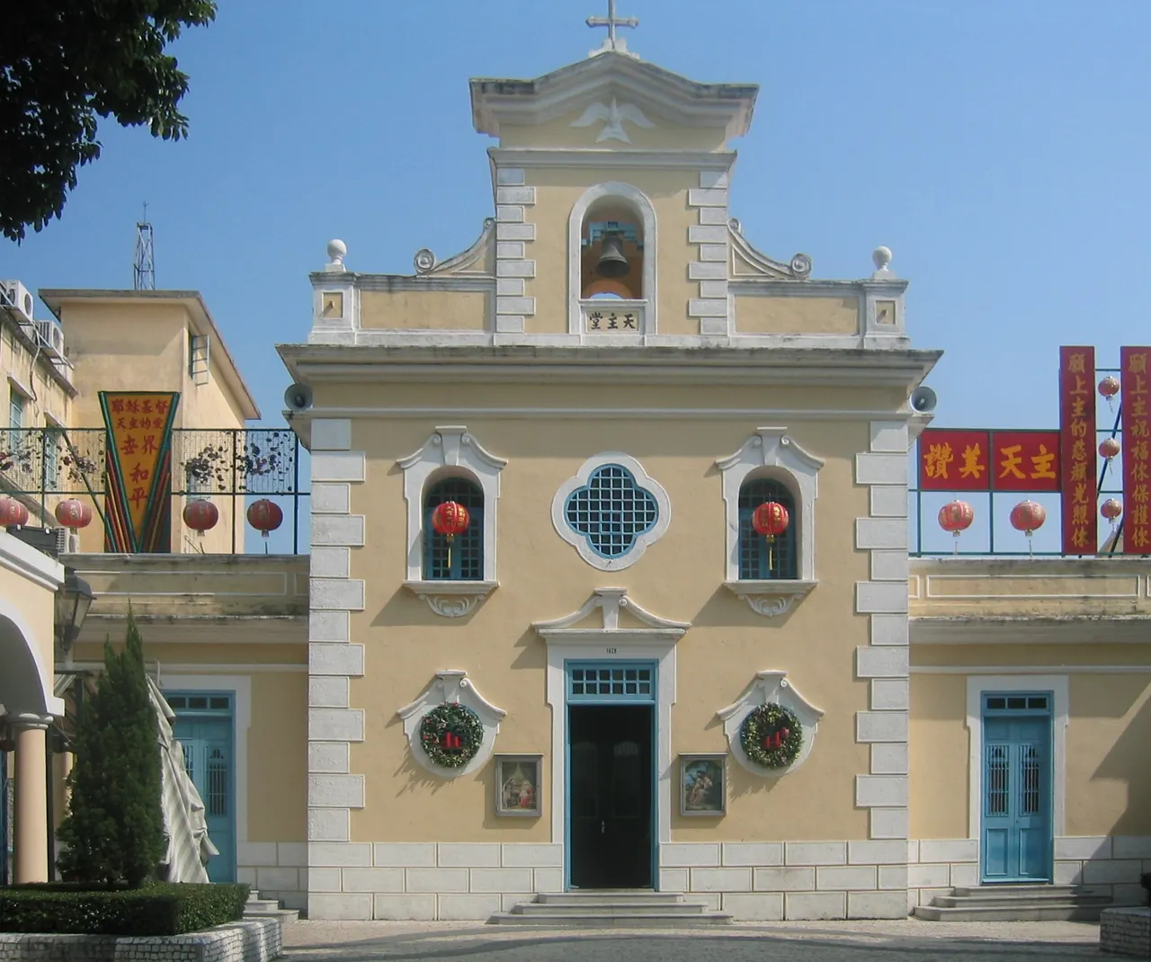 The pale-yellow facade of St Francis Xavier Chapel in Coloane