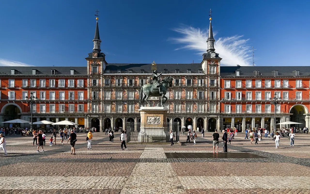 Plaza Mayor's red arcaded facades and the equestrian statue at its centre