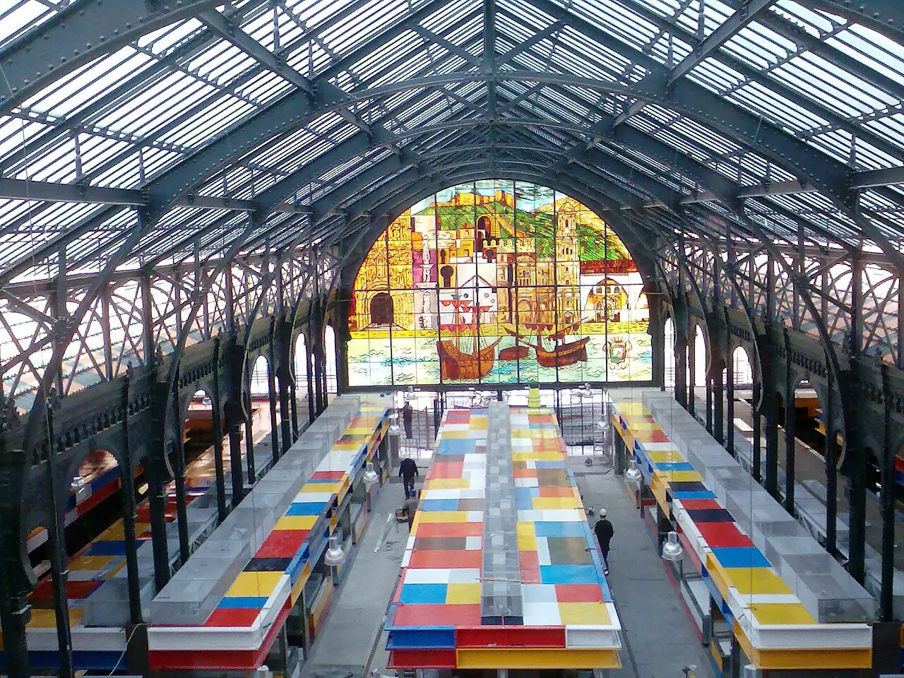 The iron roof, stalls and stained-glass window inside Atarazanas Market