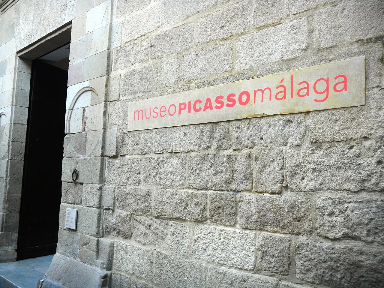 The stone doorway and museum sign at the Picasso Museum in Malaga