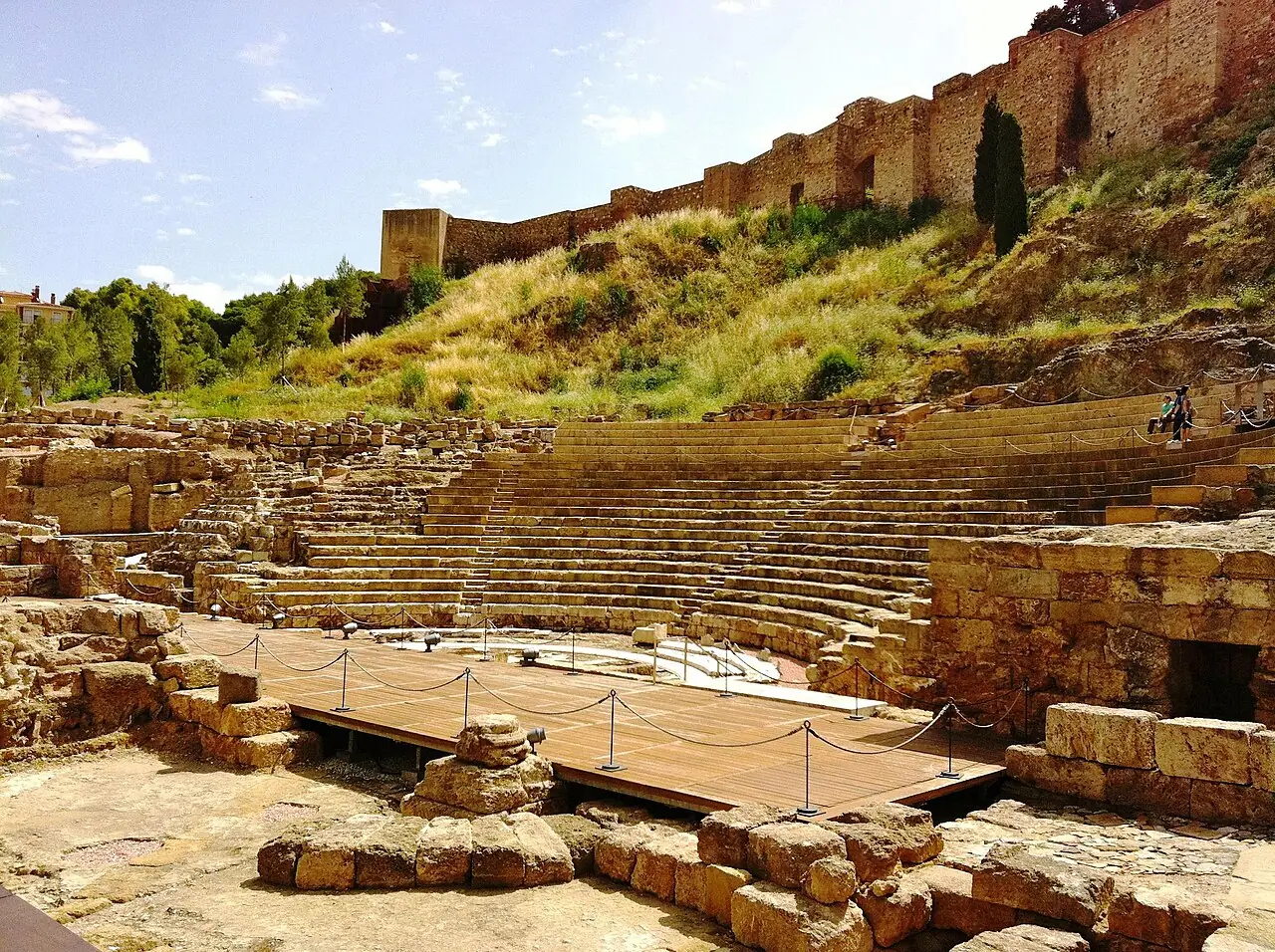 The curved stone seating of Malaga's Roman theatre beneath the Alcazaba
