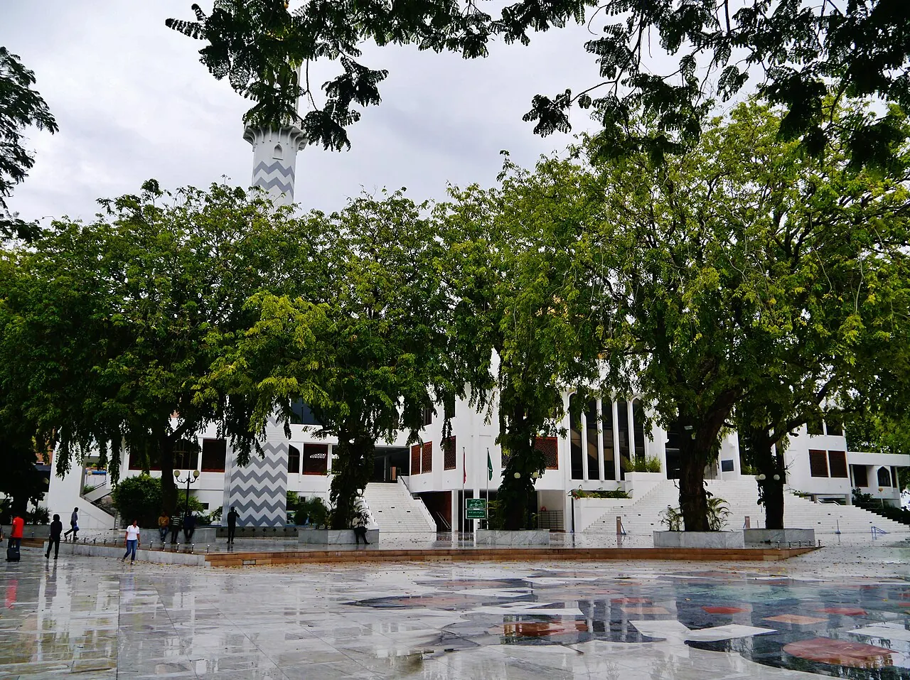 The Islamic Centre's white entrance steps and courtyard beneath large trees